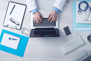 Doctor Working At Office Desk 1500x1000